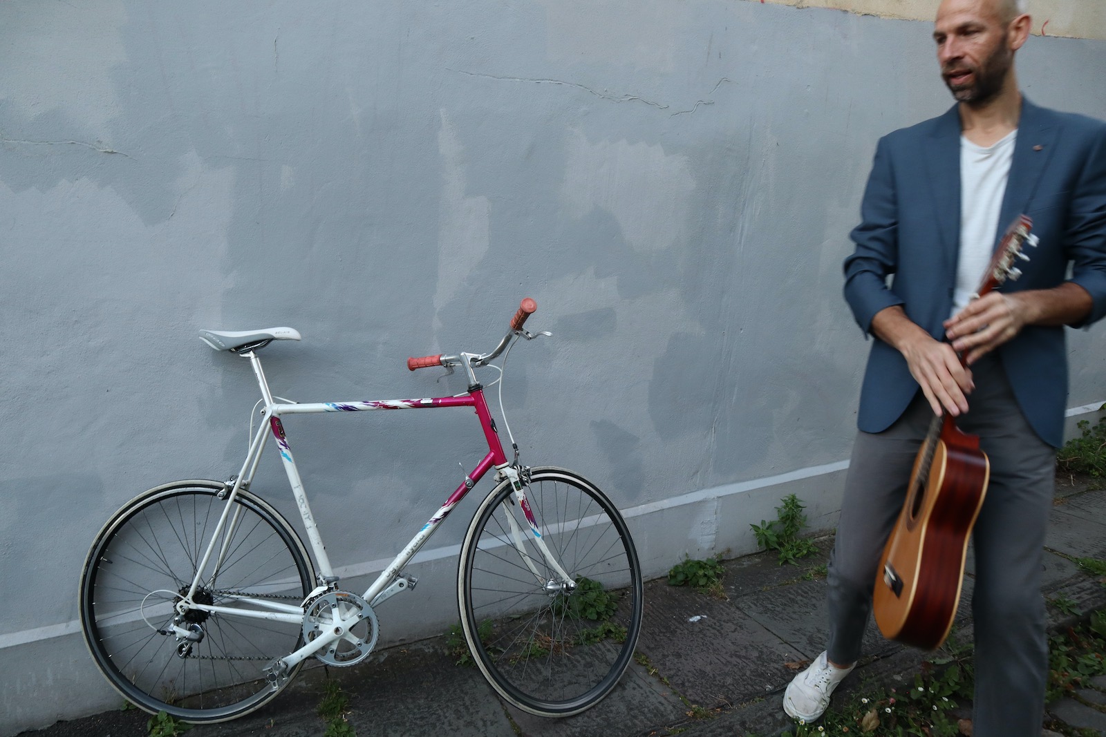 Jake Morgan with guitar beside a bicycle