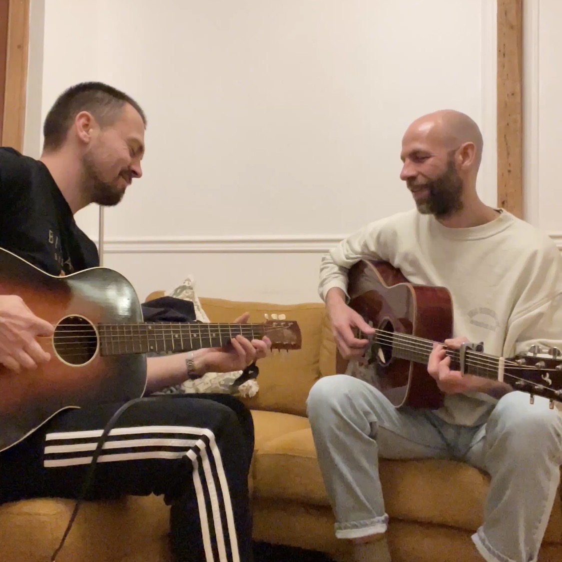 Jake Morgan and Rob Mundy rehearsing with acoustic guitars